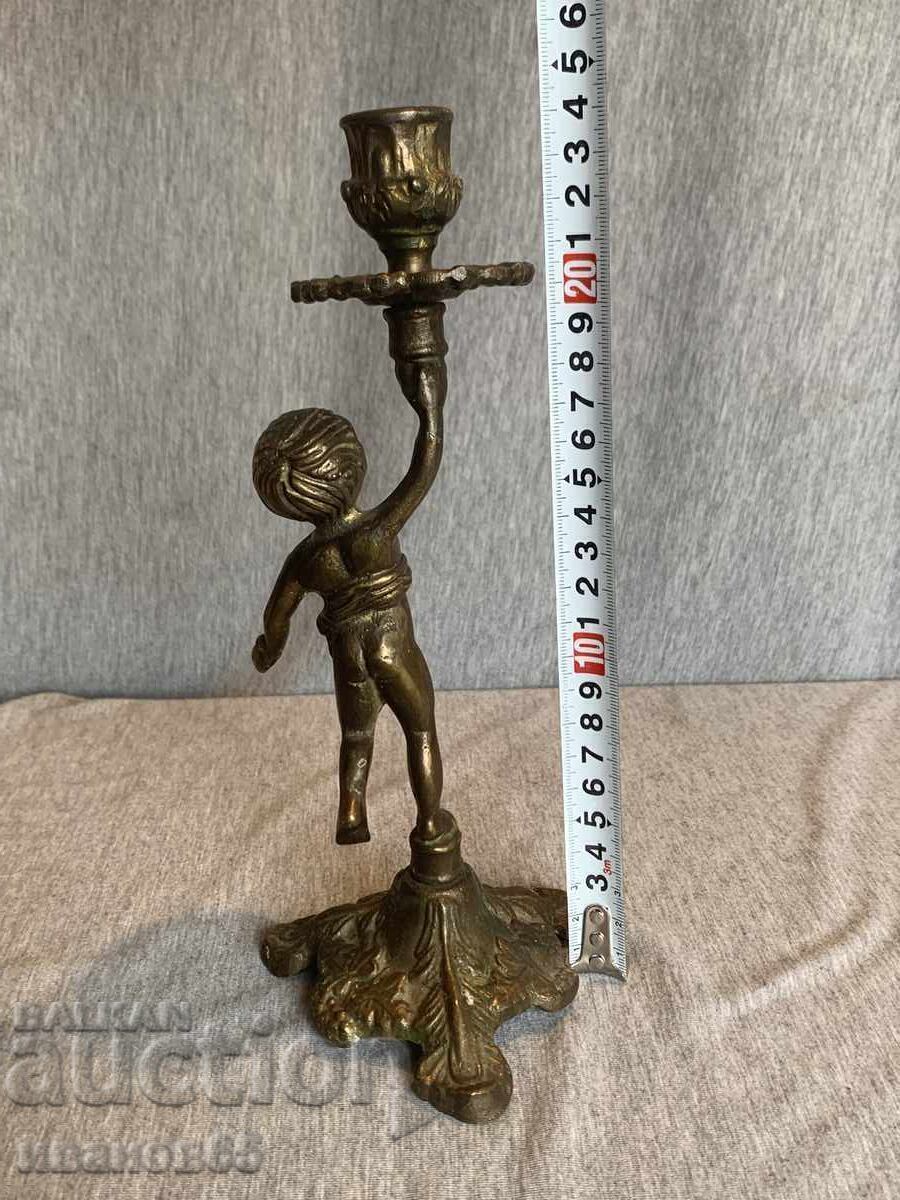 Auction Brass candlestick holder for a candle with an angel Auction Brass candlestick holder for a candle with an angel