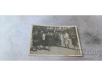 Photo: Young men and women on a railway station platform