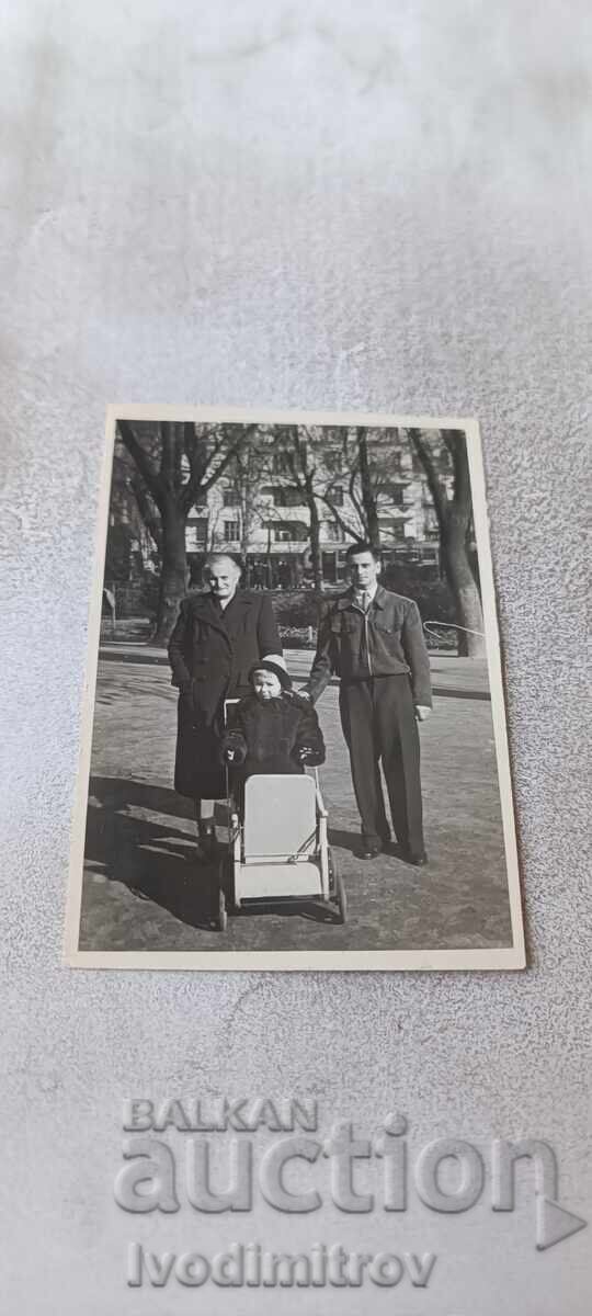 Photo Sofia Two men and a little girl with a vintage baby carriage Photo Sofia Two men and a little girl with a vintage baby carriage