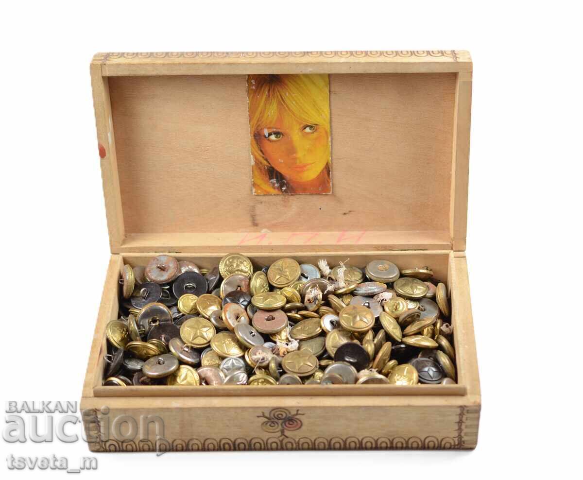 Wooden box filled with military buttons