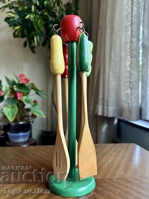 Vintage wooden kitchen utensil set on a stand