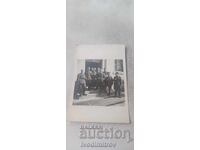 Photograph Officers and soldiers in front of an administrative building