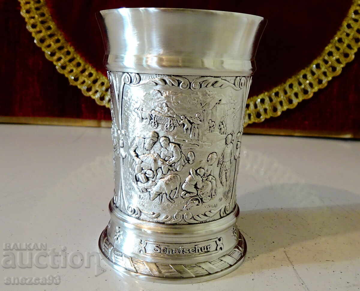 Delivery of Pewter mug with colorful village scenes