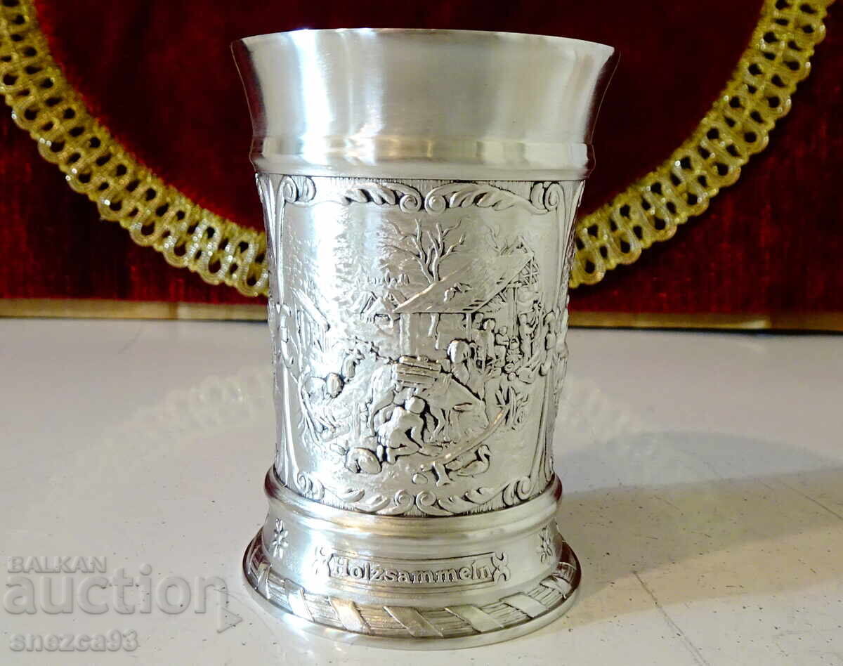 Pewter mug with colorful village scenes