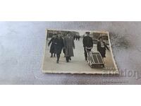 Photo Sofia Women and men with a vintage baby carriage on a walk