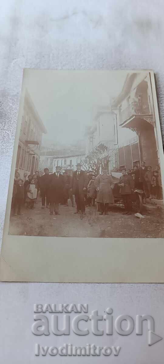 Photograph Officers men and children on a street somewhere in Macedonia WWI